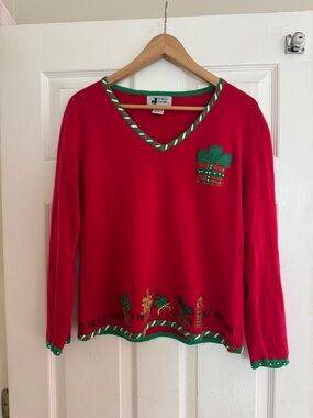 Red V-Neck Holiday Sweater with Green Trim and Gift Appliqué